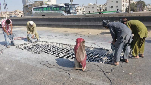a crater like pothole emerged on the carpeted surface of one track of the water pump flyover on thursday night affecting the traffic flow photo express a crater like pothole emerged on the carpeted surface of one track of the water pump flyover on thursday night affecting the traffic flow photo express