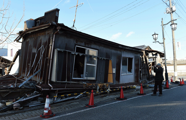 a participant of quot dark tourism quot looks at an abandoned house in namie fukushima prefecture after tsunami disaster and accident of fukushima nuclear plant on february 11 2016 photo afp a participant of quot dark tourism quot looks at an abandoned house in namie fukushima prefecture after tsunami disaster and accident of fukushima nuclear plant on february 11 2016 photo afp
