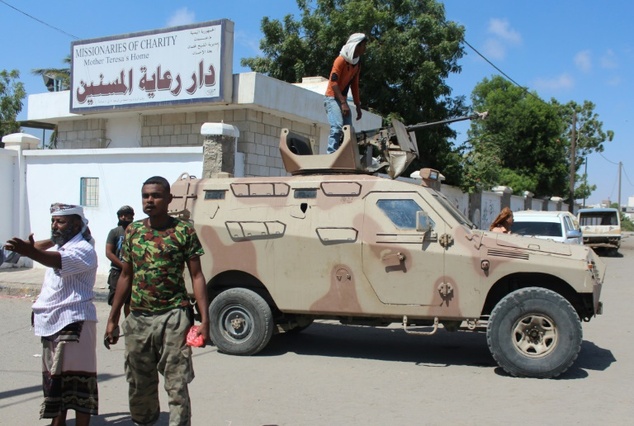 yemeni pro government fighters gather outside an elderly care home in the southern city of aden after it was attacked by gunmen on march 4 2016 killing at least 16 people photo afp