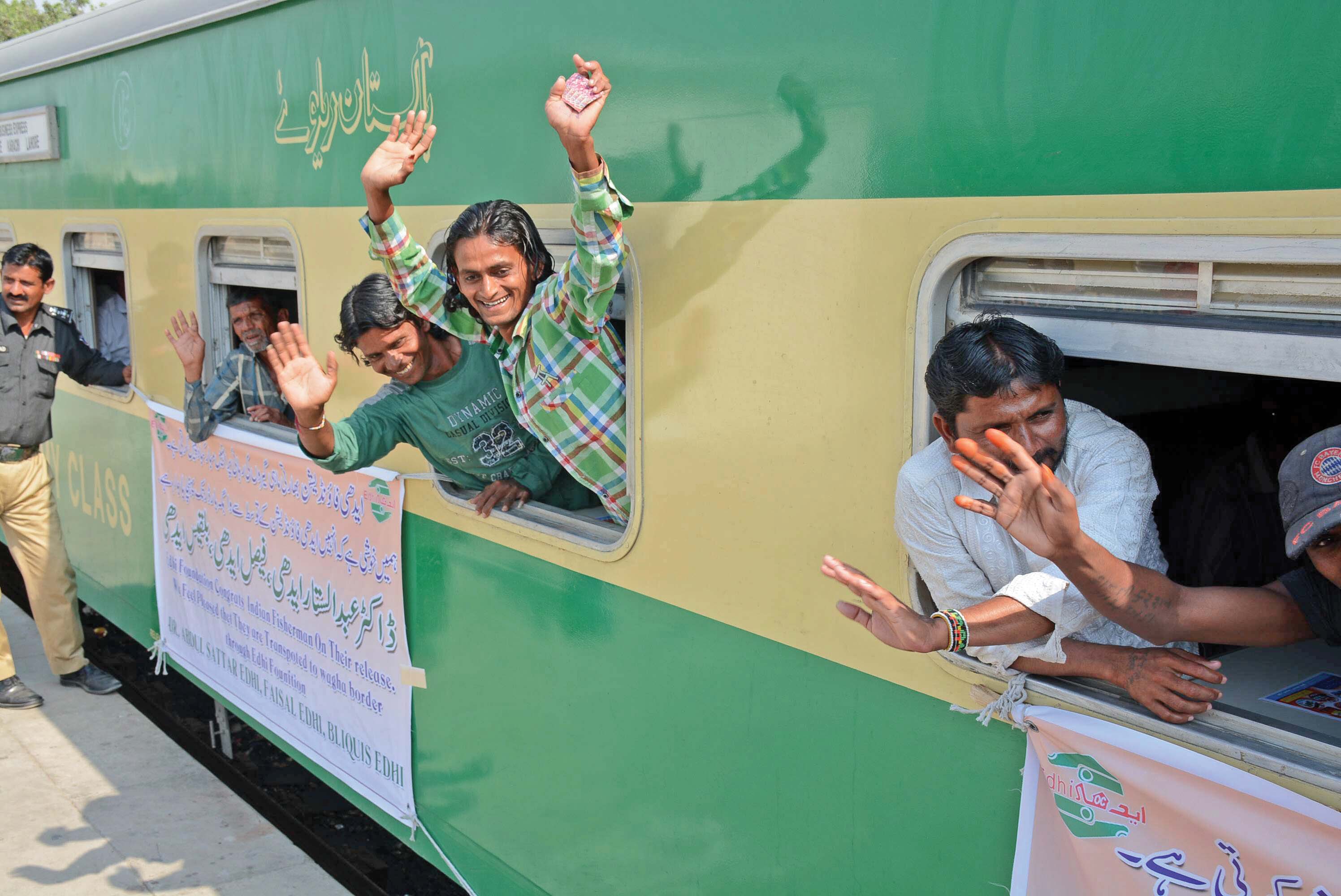 indian fishermen wave after boarding a lahore bound train at the karachi cantonment station photo mohammad azeem express