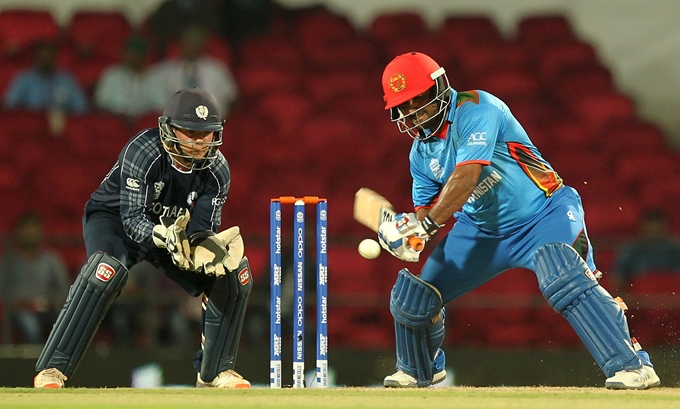 mohammad shahzad r is watched by scotland 039 s matt cross as he plays a shot during world t20 match in nagpur on march 8 2016 photo afp
