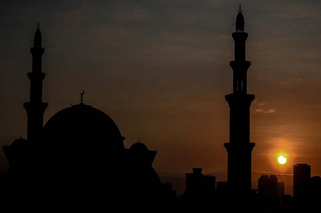 a general view shows a partial solar eclipse behind the wilayah mosque in kuala lumpur on march 9 2016 photo afp