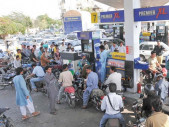 people wait in line at a petrol pump file photo people wait in line at a petrol pump file photo