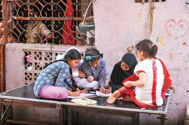 children sit outside their house doing their homework in ranchore lines during the power shutdown on friday photo online children sit outside their house doing their homework in ranchore lines during the power shutdown on friday photo online