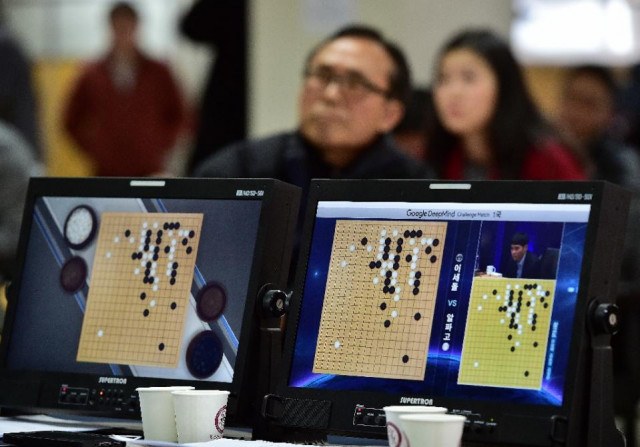 go game fans watch a tv screen broadcasting live footage of the google deepmind challenge match at the korea baduk association in seoul on march 9 2016 photo afp