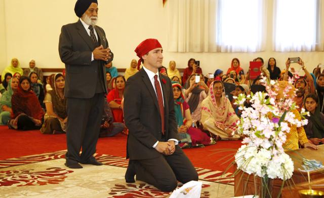 canadian prime minister justin trudeau kneels as he arrives at the gurdwara sahib ottawa sikh society in ottawa canada photo reuters