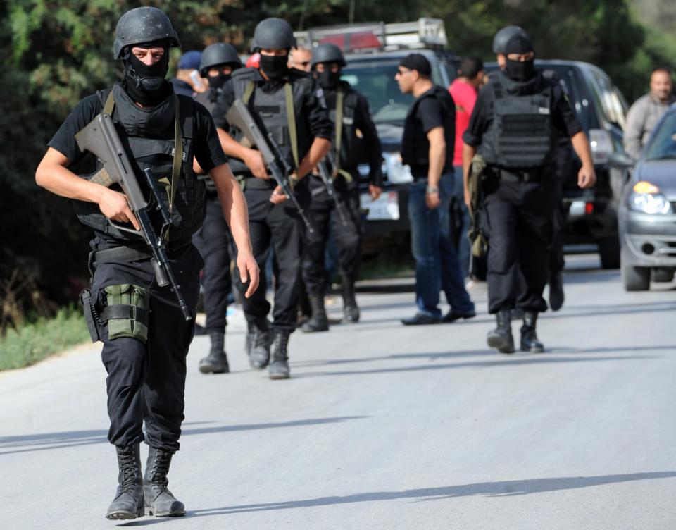 tunisian security forces are deployed outside a house where gunmen had taken refuge in the town of oued ellil on october 23 2014 photo afp