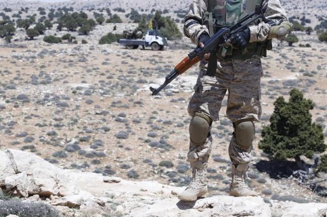 a lebanon hezbollah fighter carries his weapon as he stands in khashaat in the qalamoun region after they advanced in the area may 15 2015 photo reuters