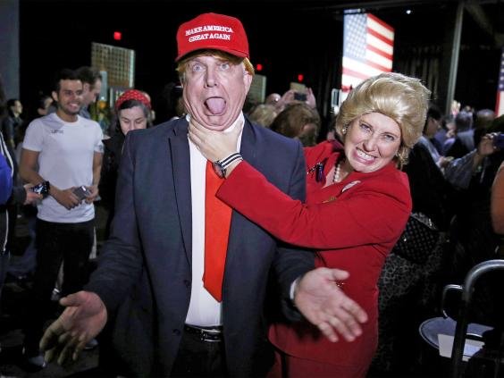 supporters of democratic presidential candidate hillary clinton take aim at donald trump in miami florida on super tuesday photo reuters