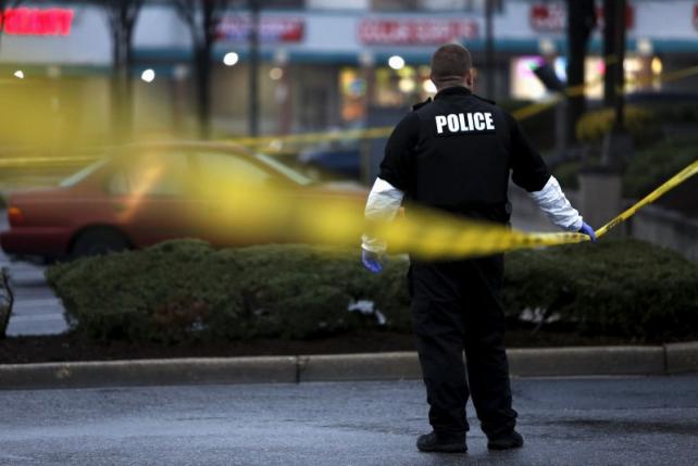 a police officer takes part in a search for evidence in the shooting of a prince george 039 s county police officer in landover maryland march 13 2016 photo reuters