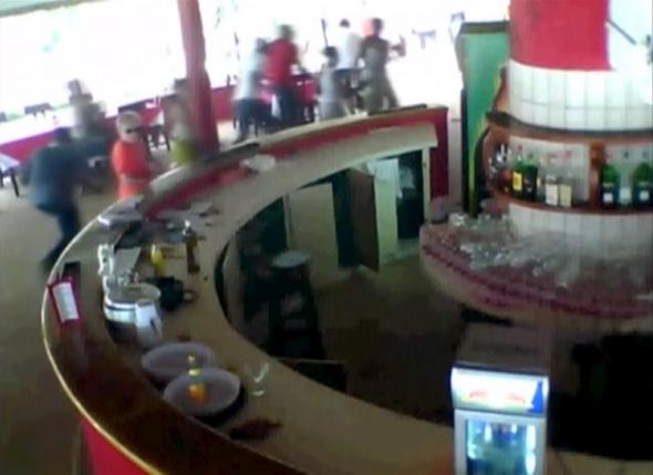 a still image taken from security camera footage shows people running for safety as shots are fired at the beach resort in grand bassam ivory coast march 13 2016 photo reuters