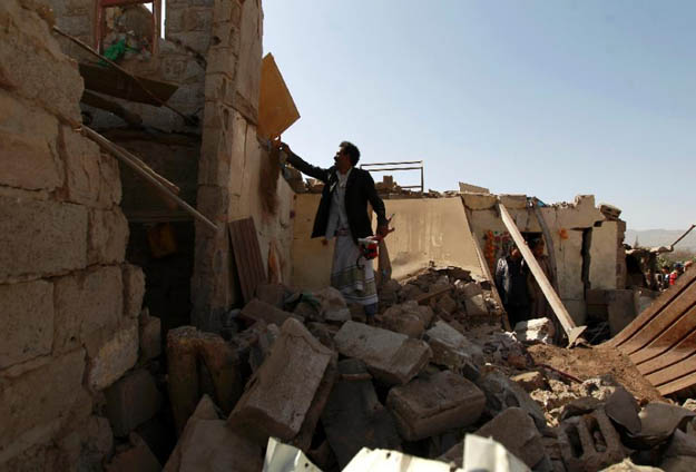 a yemeni man checks the ruins of buildings destroyed in an air strike by the saudi led coalition on february 25 2016 in the capital sanaa photo afp