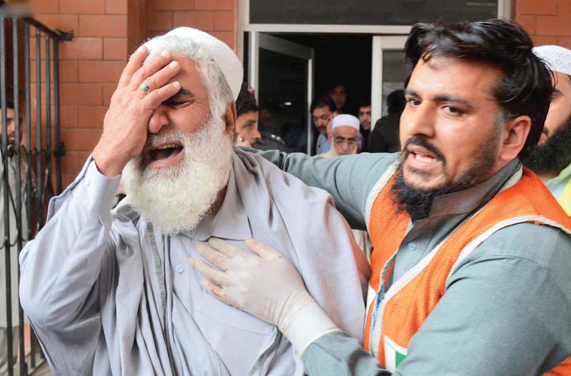 a man mourns the death of his relative at a hospital photo inp