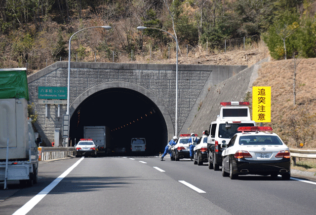 police vehicles gather at the entrance of the 860 metre hachihonmatsu tunnel in hiroshima prefecture on march 17 2016 photo afp