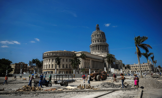 workers repair a street near the capitol in havana on march 16 2016 during preparations ahead of us president barack obama 039 s visit photo afp