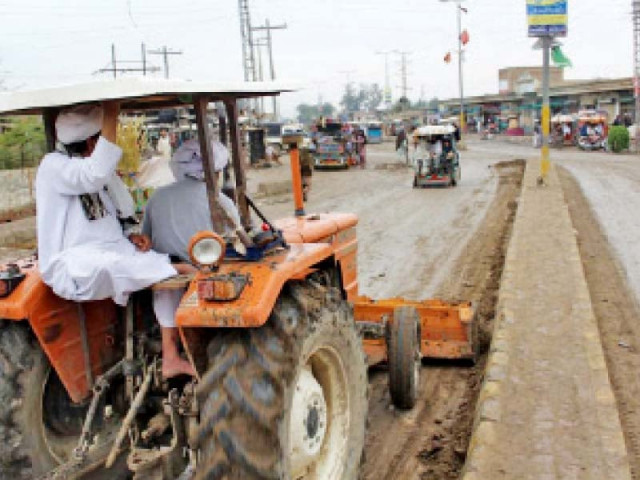 tank naib nazim cleaning a road with the help of a tractor photo express tank naib nazim cleaning a road with the help of a tractor photo express