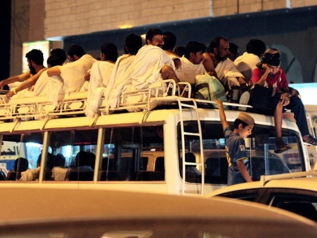 pilgrims sit on top of a bus in makkah photo afp file