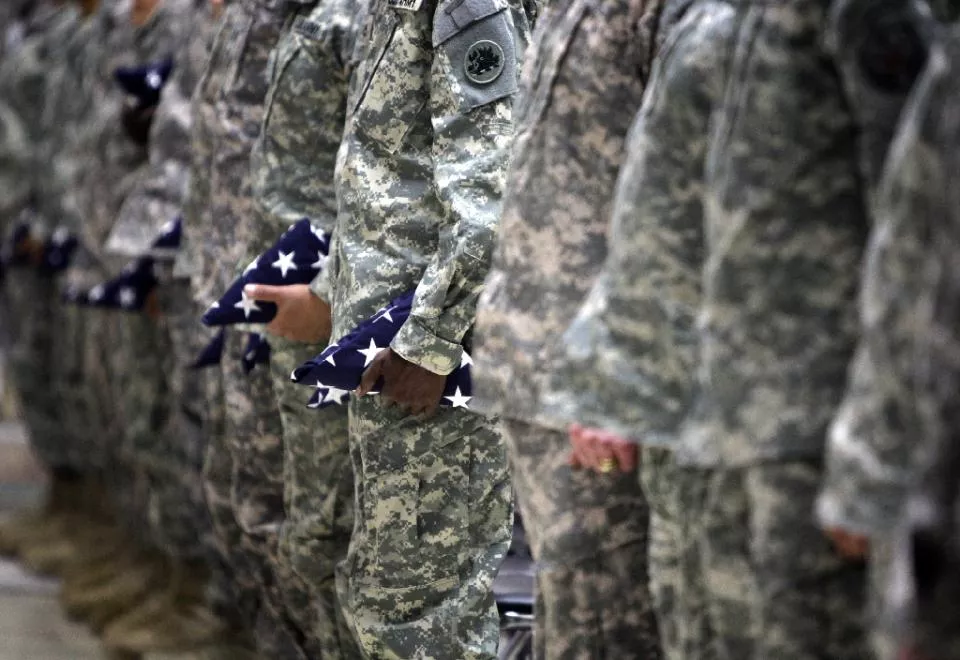 us soldiers hold a folded stars and stripes as they attend a naturalisation ceremony at al faw palace in baghdad 039 s camp victory on november 11 2010 photo afp us soldiers hold a folded stars and stripes as they attend a naturalisation ceremony at al faw palace in baghdad 039 s camp victory on november 11 2010 photo afp
