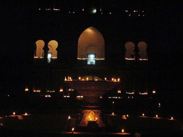 town hall seen lit with candles during earth hour photo online