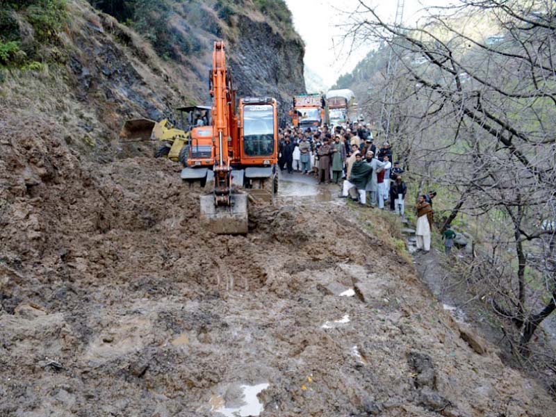 an excavator clears a road closed by a landslide near alpuri in shangla district photo inp