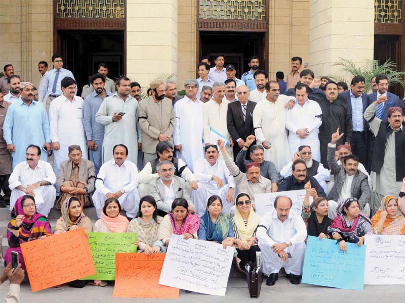 ppp lawmakers gathered on monday outside the sindh assembly to protest the federal government s decision to let former president general retd pervez musharraf to travel abroad even though he is facing treason charges in court photo inp