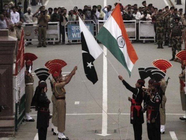 pakistani rangers wearing black uniforms and indian border security force bsf officers lower their national flags during a daily parade at the pakistan india joint check post at wagah border near lahore november 3 2014 photo reuters