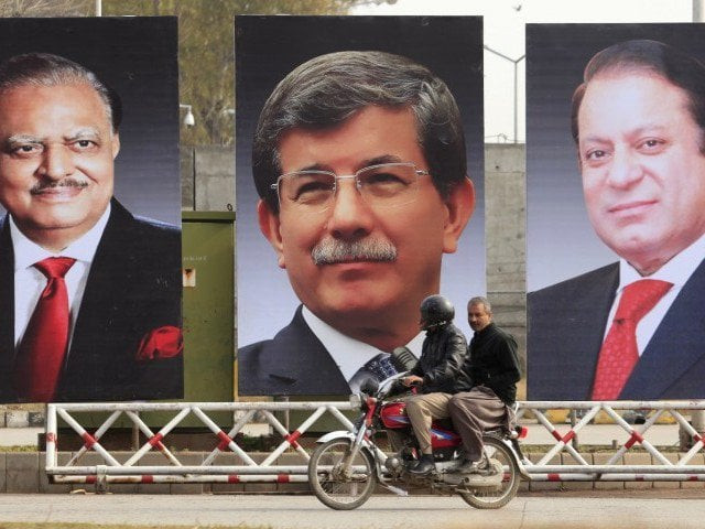 men ride a motorcycle past giant portraits of pakistan 039 s president mamnoon hussain turkish prime minister ahmet davutoglu and pakistan 039 s prime minister nawaz sharif displayed along a road in islamabad february 17 2015 photo reuters