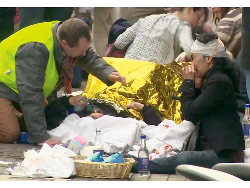 rescuers treat victims outside the maelbeek metro station in brussels photo reuters