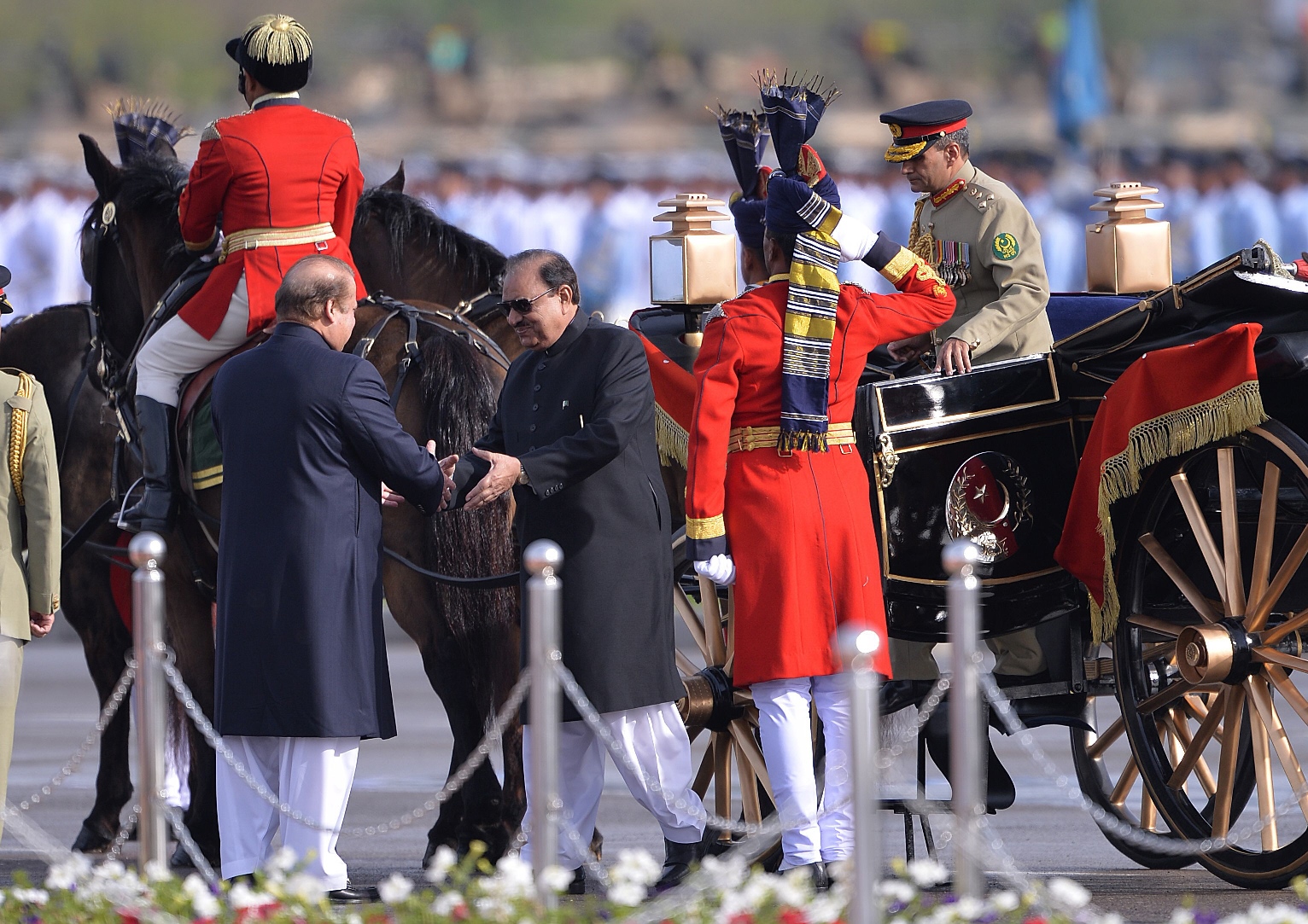 prime minister nawaz sharif l shakes hands with president mamnoon hussain as he arrives at the venue for the pakistan day military parade in islamabad on march 23 2016 photo afp