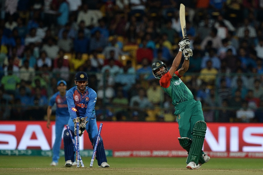 india 039 s captain and wicketkeeper mahendra singh dhoni l looks on as bangladesh 039 s captain mashrafe bin mortaza is bowled during the world t20 cricket tournament match between india and bangladesh at the chinnaswamy stadium in bangalore on march 23 2016 photo afp