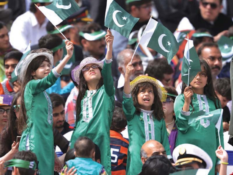 children wave flags of pakistan at the parade held here near shakarparian photos afp muhammad javaid