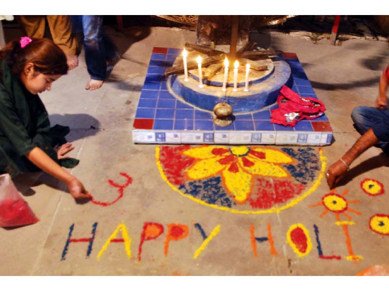 a rangoli being prepared photos agha mehroz and zafar aslam express