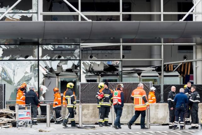 staff members at brussels national airport and rescuers stand outside the terminal for a ceremony following bomb attacks in brussels metro and belgium 039 s national airport of zaventem belgium march 23 2016 photo reuters