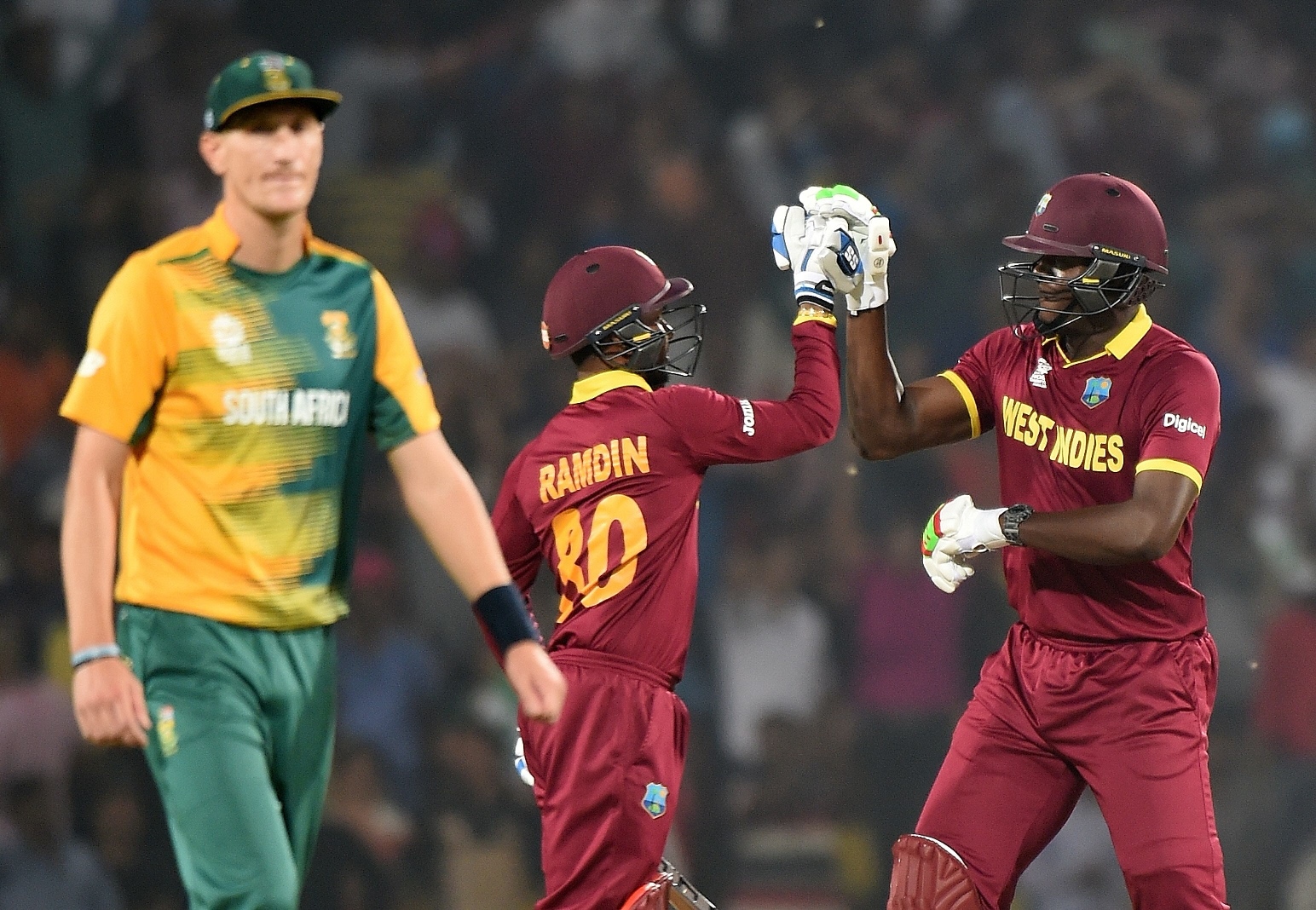 west indies batsmen carlos brathwaite r and denesh ramdin c celebrate after winning the world t20 cricket tournament match against south africa at the vidarbha cricket association stadium in nagpur on march 25 2016 photo afp