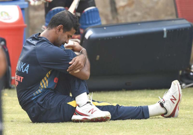 sri lanka s nuwan kulasekara stretches during a training session on the eve of their must win match against england at the feroz shah kotla cricket ground in new delhi photo afp