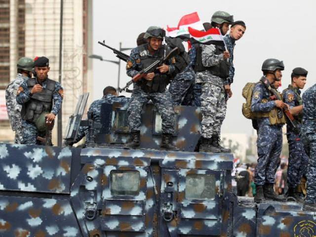 iraqi security forces stand guard during a protest on march 25 2016 outside the main gates of baghdad 039 s green zone photo afp