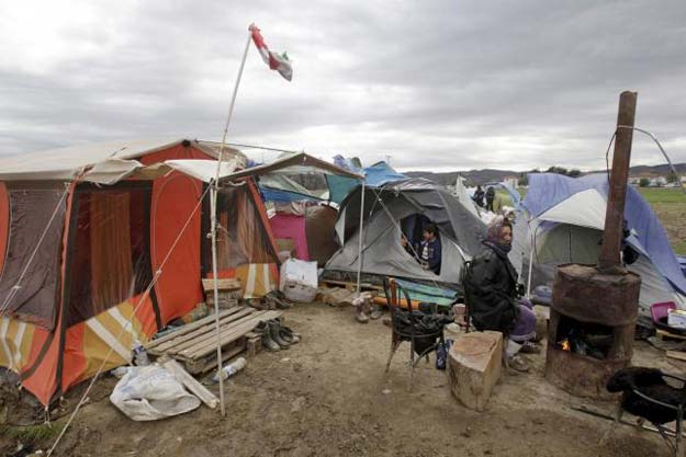 a refugee sits next to her tent in a makeshift camp for refugees and migrants at the greek macedonian border near the village of idomeni greece march 24 2016 reuters