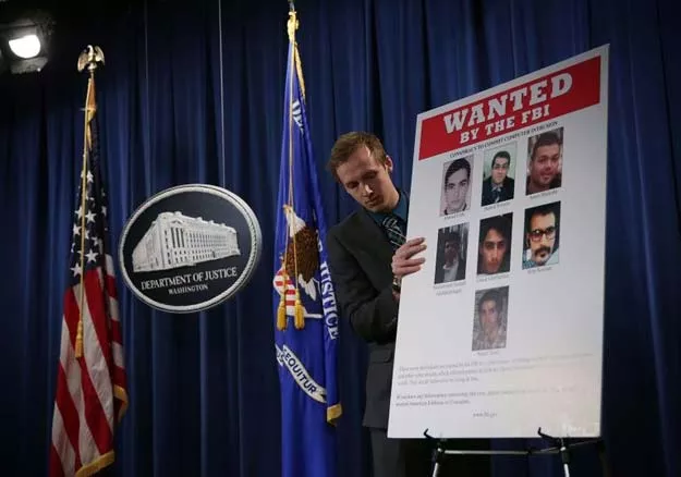 us department of justice employee puts up a poster of seven iranians indicted on computer hacking charges by a grand jury in the southern district of new york photo afp us department of justice employee puts up a poster of seven iranians indicted on computer hacking charges by a grand jury in the southern district of new york photo afp