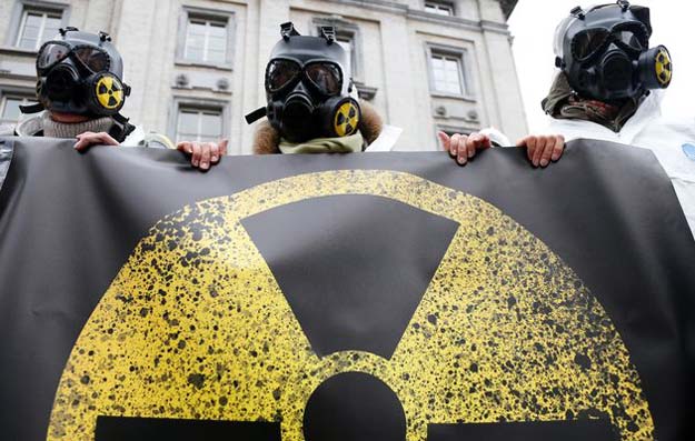 activists wearing masks and protective suits protest against what organisers said the lack of safety of belgian nuclear power plants outside the belgian interior ministry in brussels belgium photo reuters