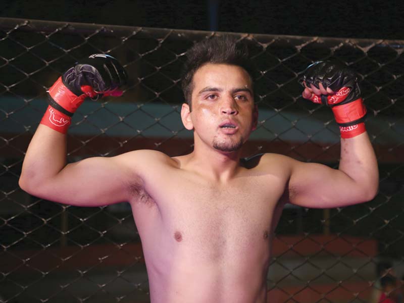 arif celebrates after defeating amanullah in his first fight at vehshi championship league photo ayesha saleem express