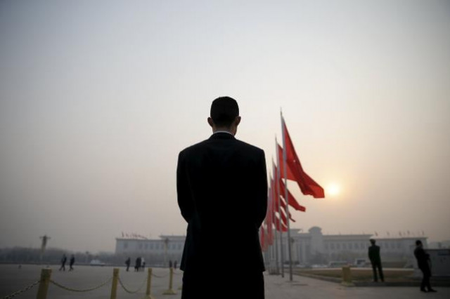 a security agent stands guard near the great hall of the people as the sun appears through smog ahead of the closing ceremony of china 039 s national people 039 s congress npc in beijing china march 16 2016 photo reuters a security agent stands guard near the great hall of the people as the sun appears through smog ahead of the closing ceremony of china 039 s national people 039 s congress npc in beijing china march 16 2016 photo reuters