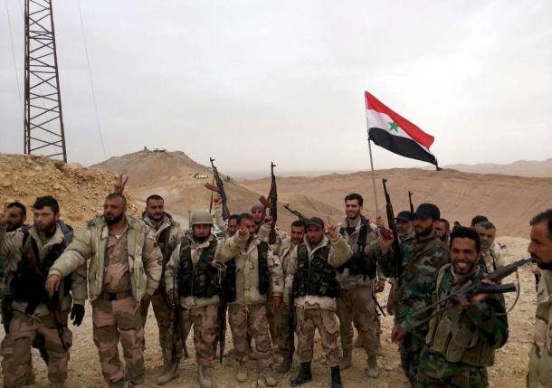 forces loyal to syria 039 s president bashar al assad flash victory signs and carry a syrian national flag on the edge of the historic city of palmyra in homs governorate in this handout picture provided by sana on march 26 2016 photo reuters