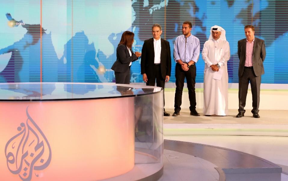 executives at qatar based al jazeera attend a welcome ceremony at the channel 039 s newsroom in doha on october 15 2015 for their freed journalist mohamed fahmy after his release from egyptian prisons photo afp