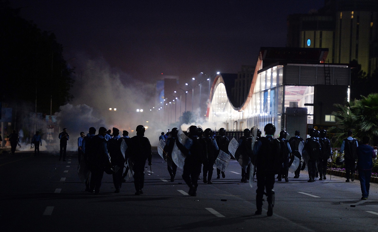 anti riot police officers walk to supporters of executed islamist mumtaz qadri during an anti government protest in islamabad on march 27 2016 photo afp