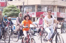 a woman and her daughter ride bicycles during the girls on bikes rally photo amel ghani