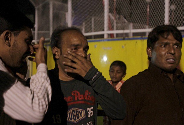 men mourn the death of their relatives after a blast outside a public park in lahore march 27 2016 photo reuters