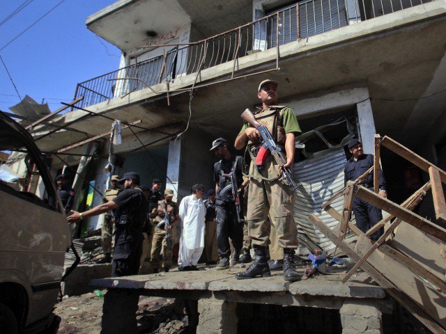 a member of the paramilitary forces stands guard at the site of a suicide bomb attack in charsadda northwest pakistan may 13 2011 photo reuters