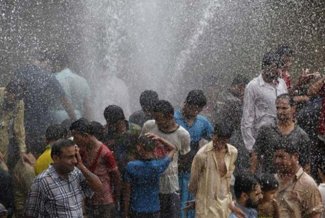 people cool off from the heat as they are sprayed with water jetting out from a leaking water pipeline in karachi pakistan june 25 2015 photo reuters people cool off from the heat as they are sprayed with water jetting out from a leaking water pipeline in karachi pakistan june 25 2015 photo reuters