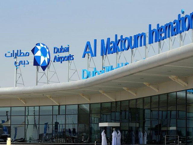 local employees stand outside the al maktoum international airport dubai photo afp local employees stand outside the al maktoum international airport dubai photo afp