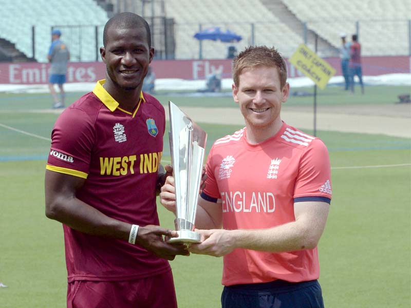 west indian skipper darren sammy poses with the world t20 trophy alongside his england counterpart eoin morgan ahead of the final clash between the two sides photo afp
